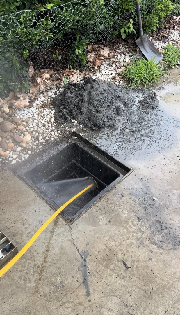 Cleaning concrete off the pavement with a hose